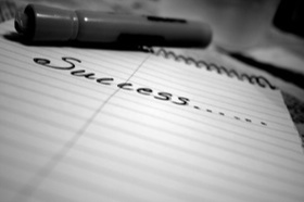 "Success" written on a notepad.